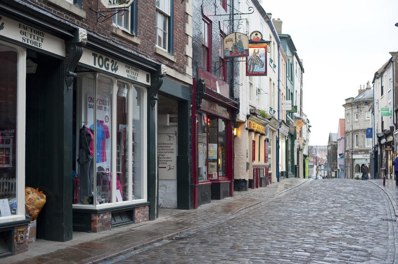 Quaint old shops on Church Street in Whitby which is one of the oldest shopping streets and runs right up to the 199 steps that lead up to St Marys Church on Tate Hill
