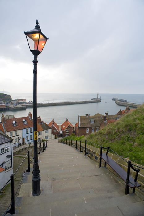View looking down the 199 Steps church stairs in Whitby which lead from the town to St Mary's Church on Tate Hill towards the harbour entrance and piers