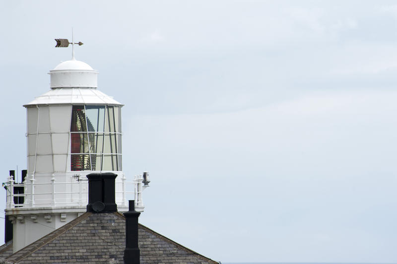 Close view of a white lighthouse lantern room. Copy space