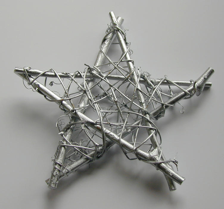 Rustic wicker Christmas star decoration for celebrating the festive season on a grey background