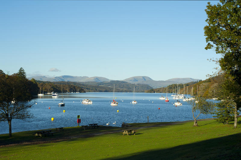 Beautiful scenic view of pleasure boats and yachts on the calm water of Lake Windermere in the English Lake District in Cumbria