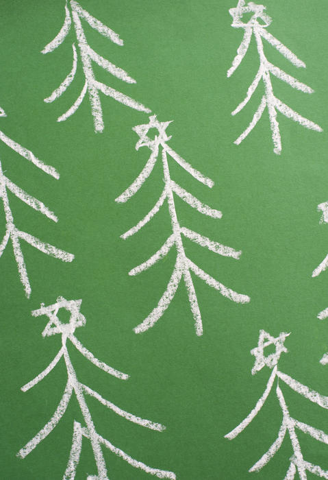 a vertical format background composed of tree shapes with stars drawn in white chalk on an angled green surface