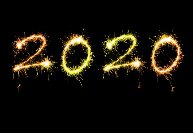 New years 2020 sparkling sign with golden orange digits floating isolated against black background