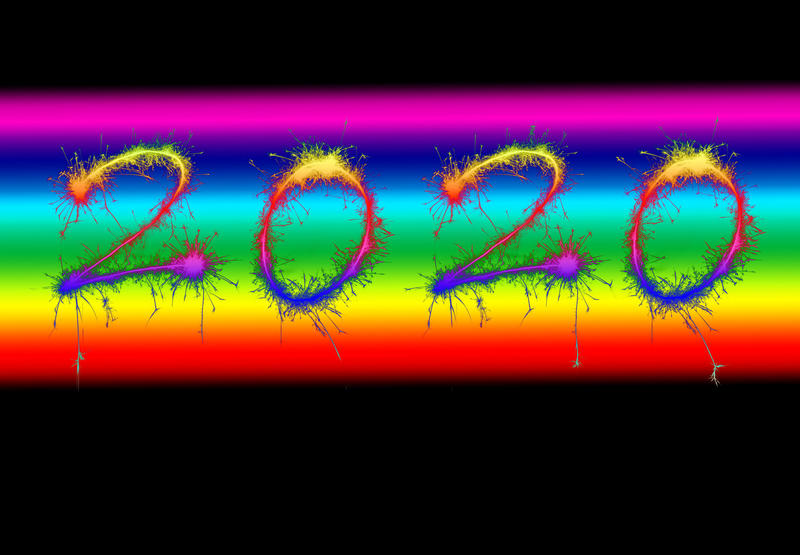 2020 New Year date on a rainbow colored background over black with copy space for a holiday greeting