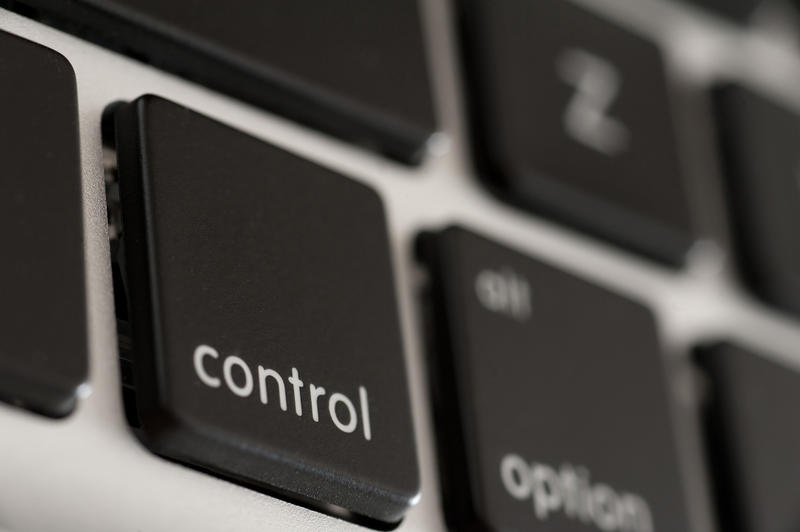 Close up macro of the control key on a black computer keyboard viewed at an oblique angle with copy space