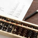 12722   Business balance sheet with abacus and pen