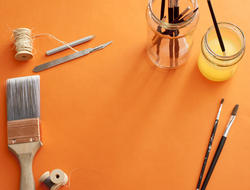 12140   Orange background bordered with art supplies