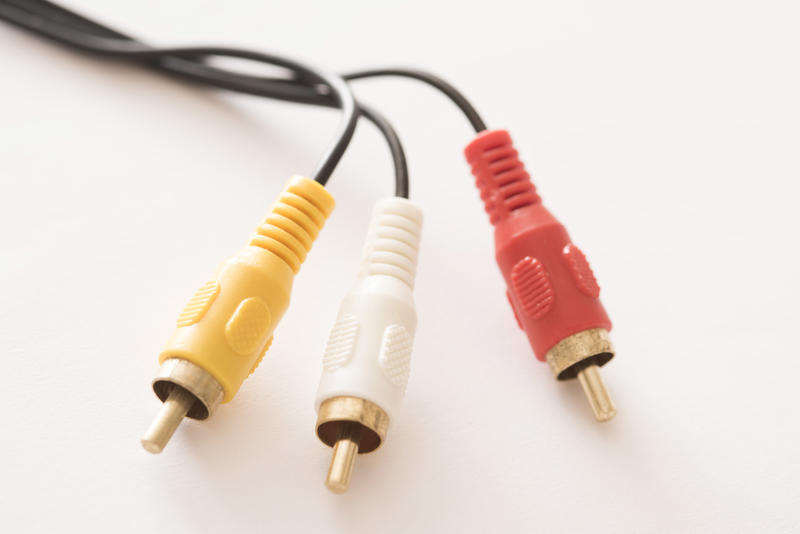 Close-up view of RCA cable connector for video and two audio stereo channels on white background