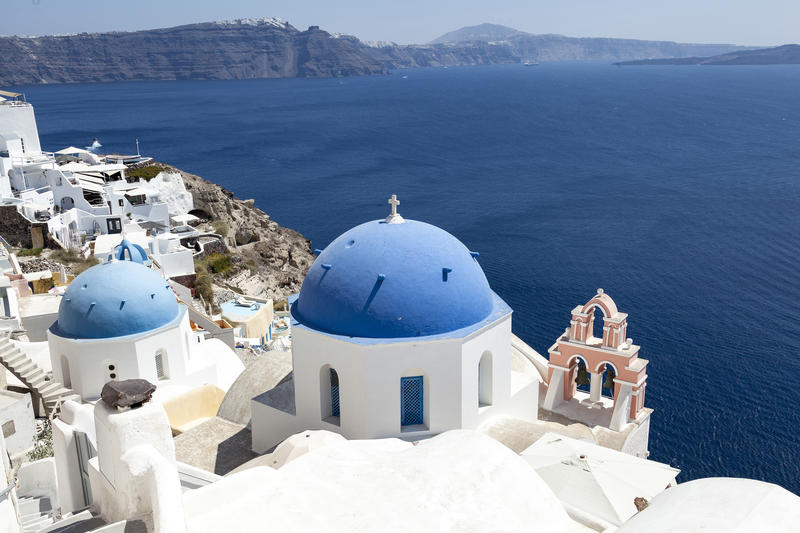<p>Blue domed churches are a traditional feature of Oia in Santorini and they make a stunning scene against the traditional white buildings.</p>