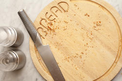 17142   Stainless steel knife and bread board with crumbs