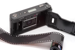 12148   Exposed roll of film next to pocket camera