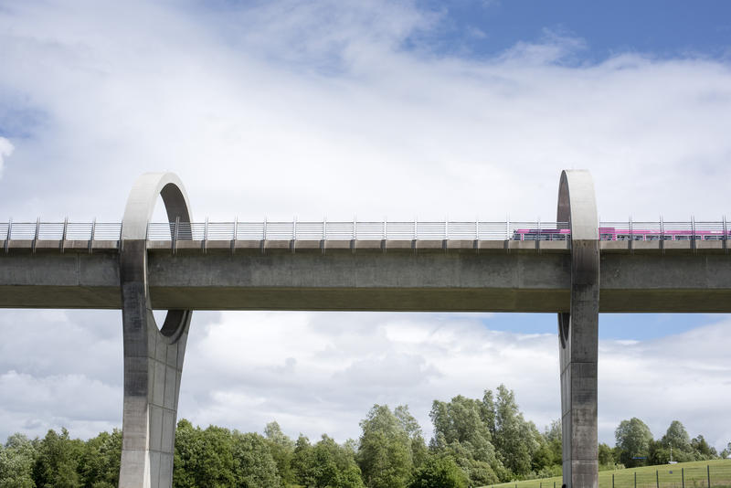 Low angle view up toward boat moving along viaduct near the Falkirk Wheel boat lift in Scotland