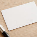 12729   Blank white card with a ball point pen