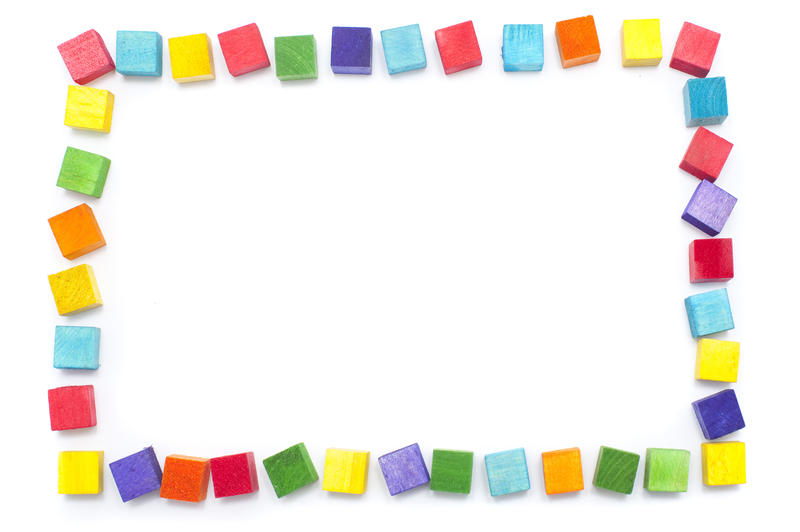 Colorful kiddies frame of wooden building blocks in the colors of the rainbow over a white background with copy space