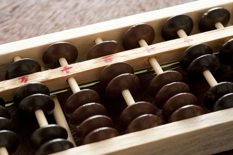 Close up detail of a wooden abacus used for manual computing and accounting
