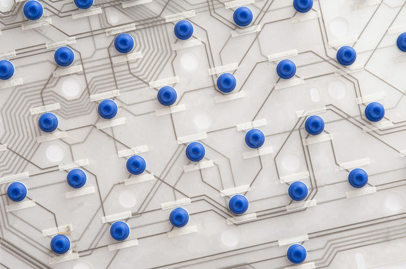 Circuit layout pattern with blue dots on white board, close-up full frame image