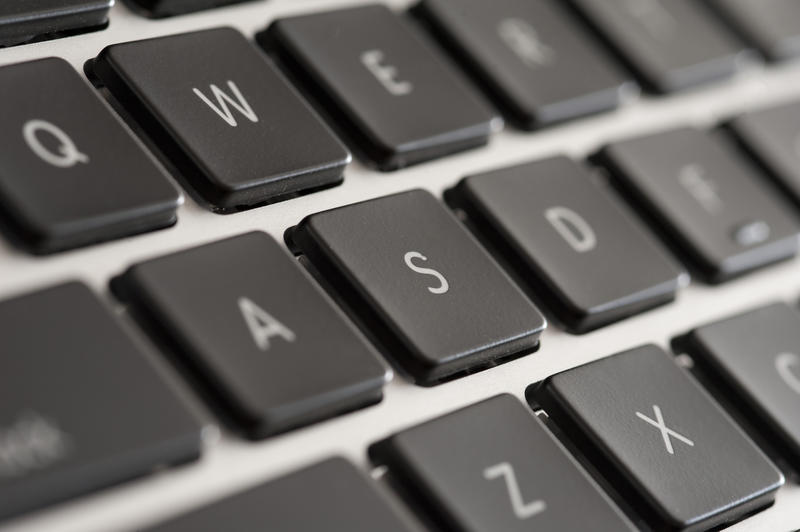 Close up Black Laptop Computer Keyboard Printed with White Letters.