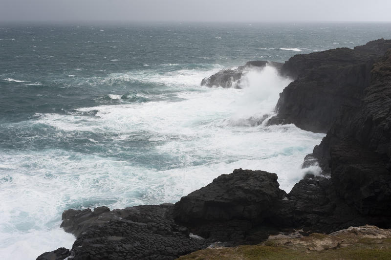 a rugged cliff lined coast with tempestuous waves