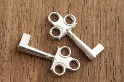 12731   Two short silver keys with single flat end