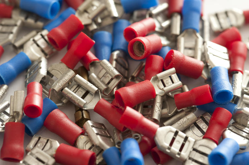 Close up on pile of red and blue new wire terminals used for low power electrical connections