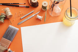 12164   Assorted painting tools around blank sheet