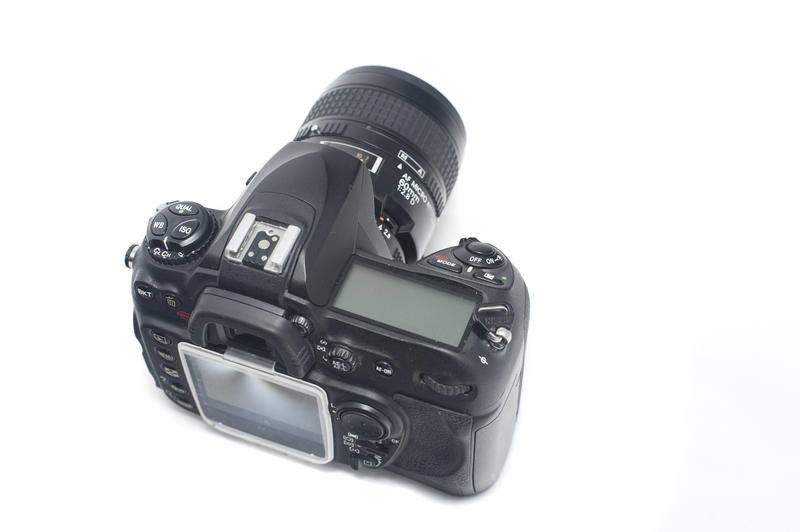 Top rear view of isolated single lens reflex digital camera over white background