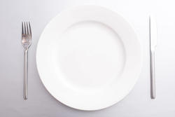 17143   Clean empty white dinner plate with cutlery