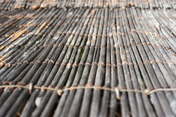 12682   Cane floor mat with strings holding it together