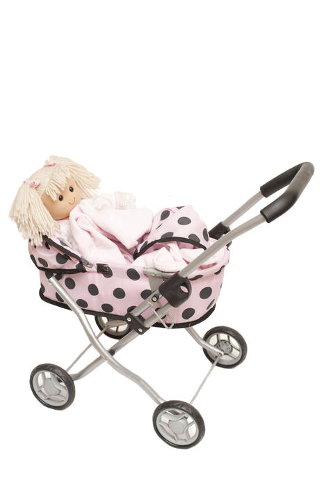 Pretty polka dot pink dolls pram with a blond dolly inside in a side view isolated on white with copy space