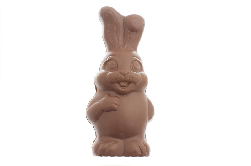 Happy fat little milk chocolate bunny Easter egg isolated on white with copy space, not in wrapper