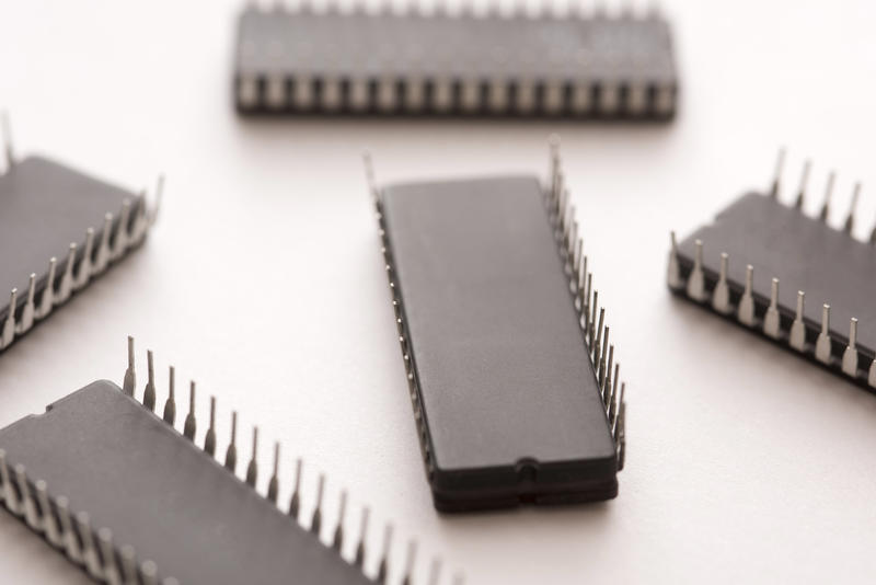 Black electronic chips upside down close-up on white surface background