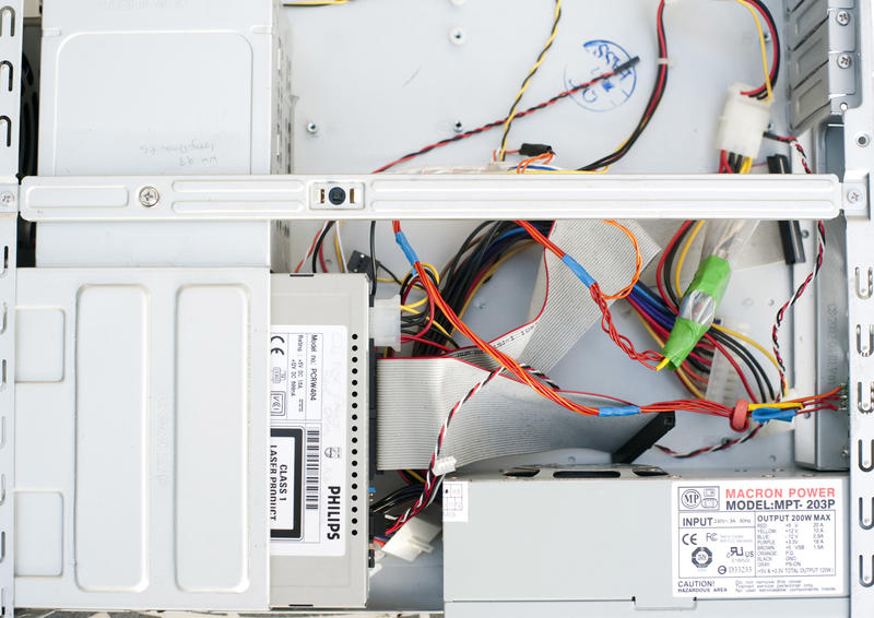 Wires and cd drive inside of empty white computer case, full frame close-up image