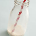 13000   Remnants of milk in a glass bottle with straw