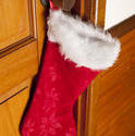 13149   Colorful red Christmas stocking hanging on a door