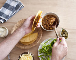 12756   filling a taco shell with ground meat