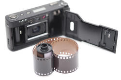 12166   Single roll of film next to compact camera