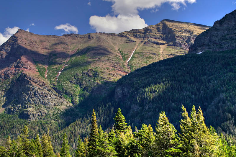 <p>Blue sky and clouds form the backdrop to this high mountain ridge at Glacier National Park.</p>

<p><a href="http://pinterest.com/michaelkirsh/">http://pinterest.com/michaelkirsh/</a></p>
