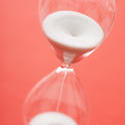 12957   Grains of white sand in an hourglass