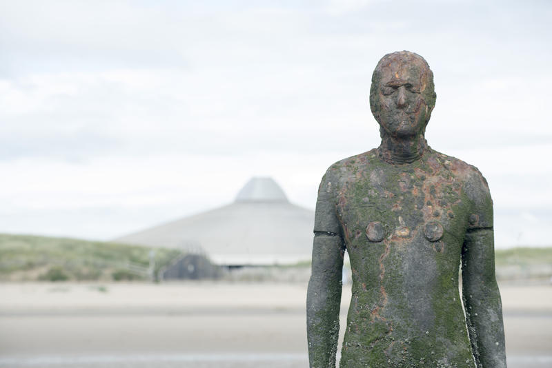 Close Up of Cast Iron Male Figure as part of Another Place Modern Sculpture Installation by Antony Gormley on Crosby Beach, England, UK