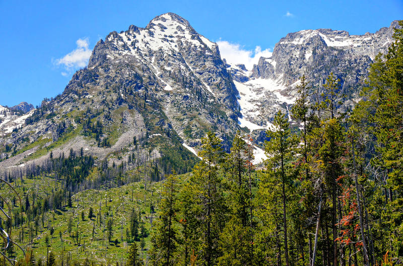 <p>Permanent snow fields lie on this dramatic mountain peak at Grand Teton National Park. &nbsp;Grand Teton National Park lies in Northwestern Wyoming about ten miles south of Yellowstone National Park.</p>
