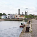 12851   Boat at pier with old cathedral in background