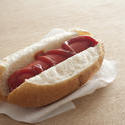12758   Single hot dog covered in ketchup