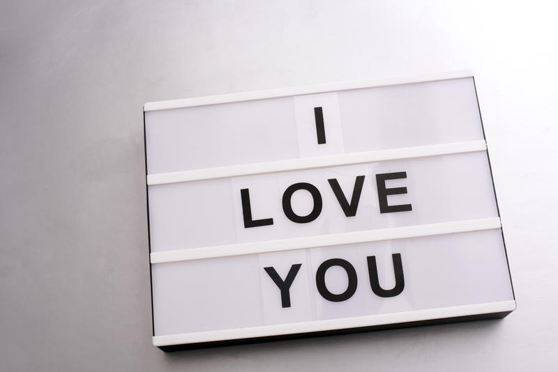 Changeable sign with I LOVE YOU letters on white background. Close-up over white surface