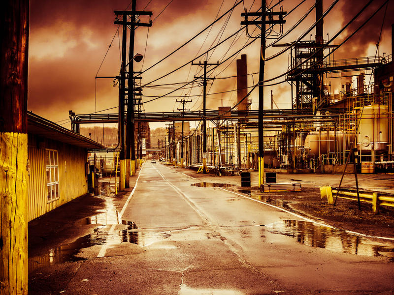 <p>Industrial complex poluting the air on a rainy day.</p>