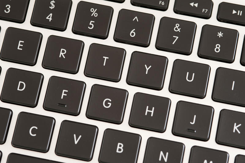Extreme close up of a laptop keyboard featuring letters and numbers three through eight