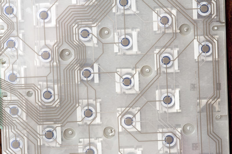 Overhead extreme close up of open keyboard exposing numerous digital connections