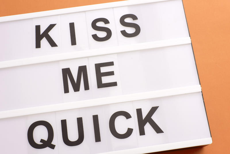 Fun - Kiss Me Quick - Valentines message in black text on a light box conceptual of love, passion, flirting and romance