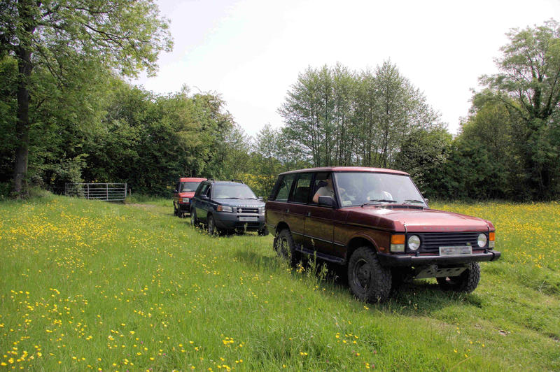 <p>4x4 vehicles pausing to enjoy the countryside. This was on a public byway near to the area known as Devil's Punchbowl, a National Trust location in Surrey, UK.</p>
