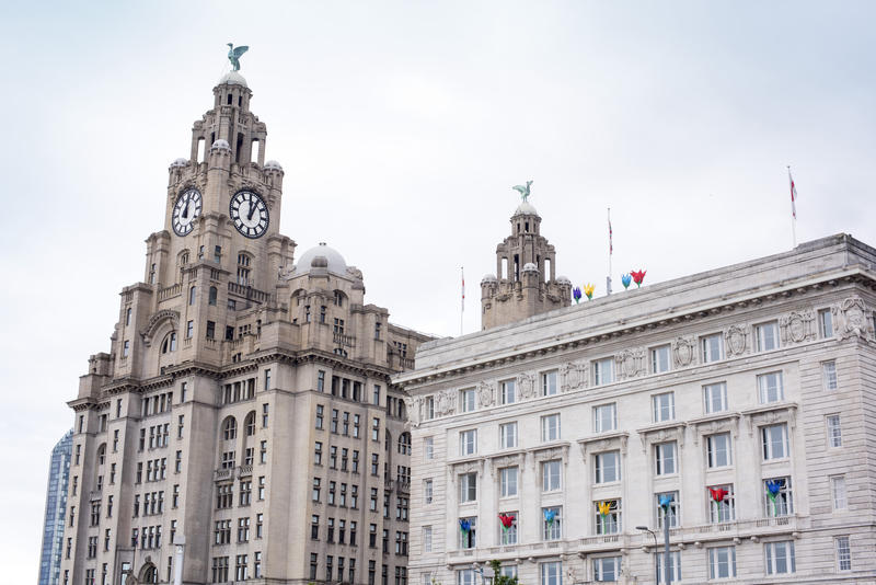 View on top section of the Liver building and clock tower in downtown Liverpool, United Kingdom