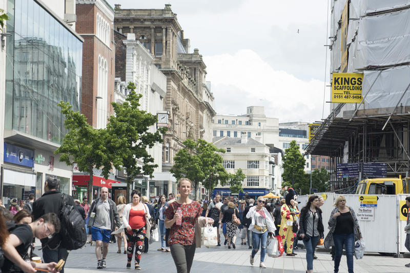 Street scene in Liverpool, UK with crowds of shoppers and pedestrians in a commercial district